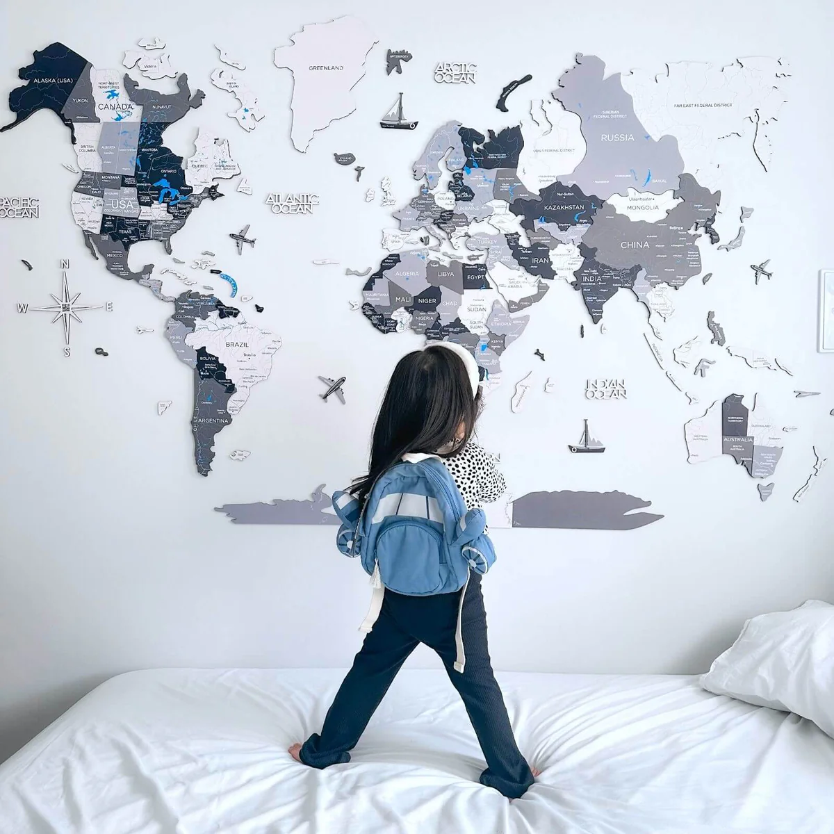 Travel ritual with a wooden push-pin world map