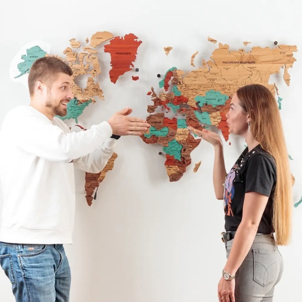 Friends marking trips on wooden map